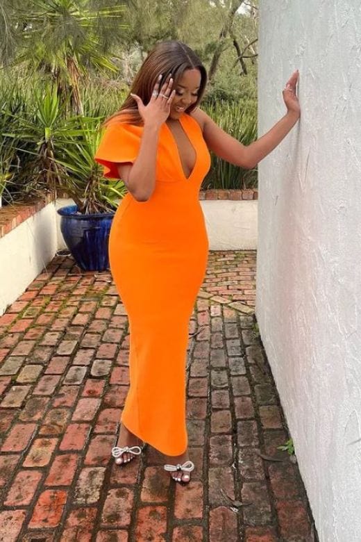 Woman wearing a figure flattering  Blake Bandage Maxi Dress - Apricot Orange BODYCON COLLECTION