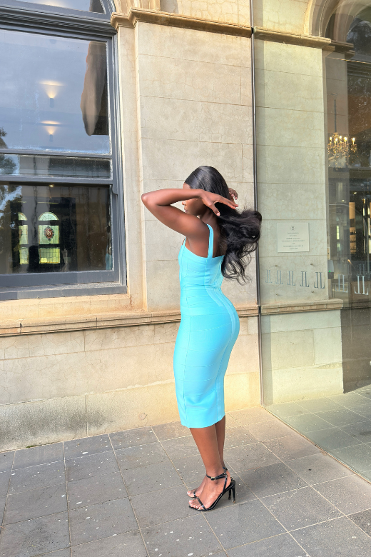 Woman wearing a figure flattering sky blue party dress Heidi Bandage Midi Dress - Sky Blue Bodycon Collection