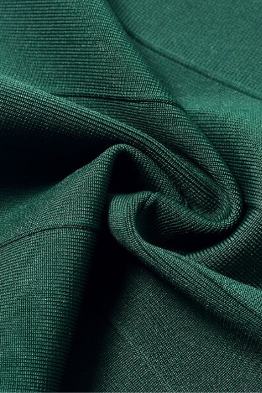 Woman wearing a figure flattering  Josie Bandage V Neck Mini Dress - Emerald Green BODYCON COLLECTION