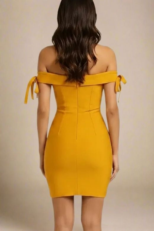 Woman wearing a figure flattering  Penelope Bandage Mini Dress - Mustard Yellow BODYCON COLLECTION