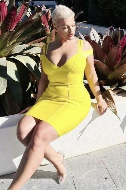 Woman wearing a figure flattering  Sia Bandage Dress - Sun Yellow Bodycon Collection
